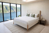 Sarnano bed in a bedroom in a Woody Point fjord house in Newfoundland, raised three-quarter view