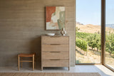 Sarnano chest in Sand seen straight on in an orchard house at Cawston, BC, against a rammed-earth wall