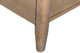Close-up of a Sarnano corner post in Sand oak running down into a short round tapered leg