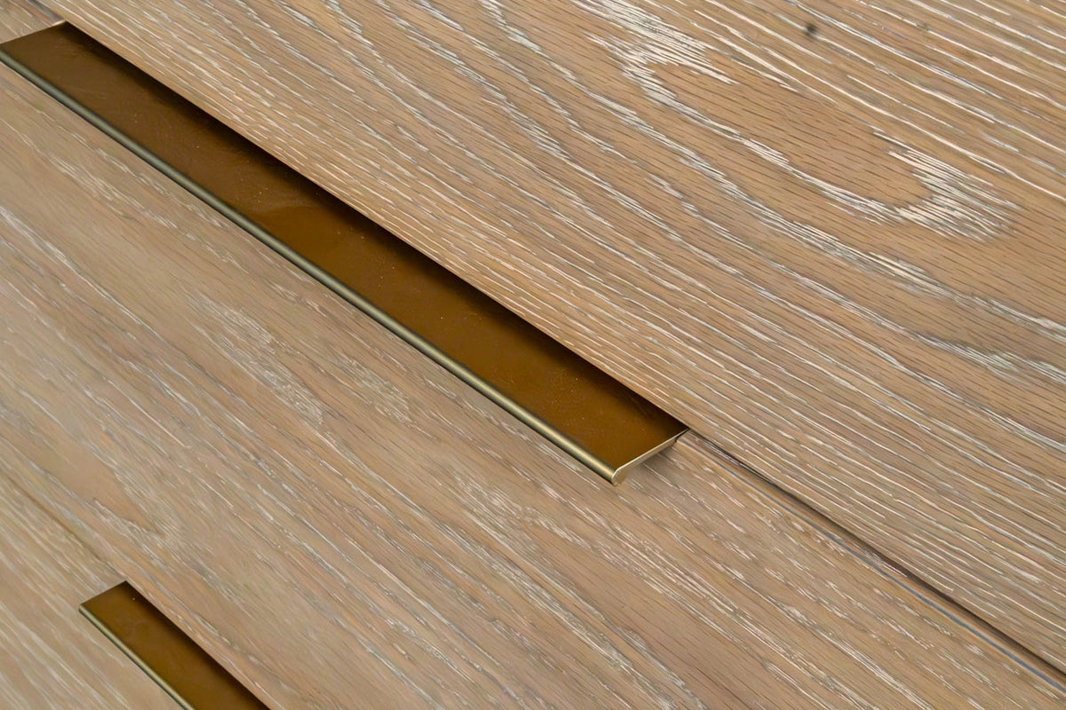 Close-up of a slim brass-finish pull on the top edge of a Sarnano drawer