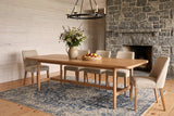 Sarnano dining table in Sand in a Muskoka cottage with whitewashed pine walls, a fieldstone fireplace