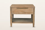 Sarnano nightstand in Sand, front view on a warm white studio backdrop: one wide drawer with a slim brass pull centred on its