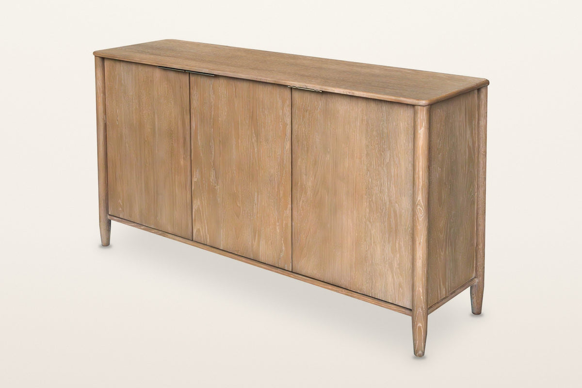 Sarnano mid-century oak sideboard in Sand, three-quarter view on a warm white studio backdrop: three flush doors