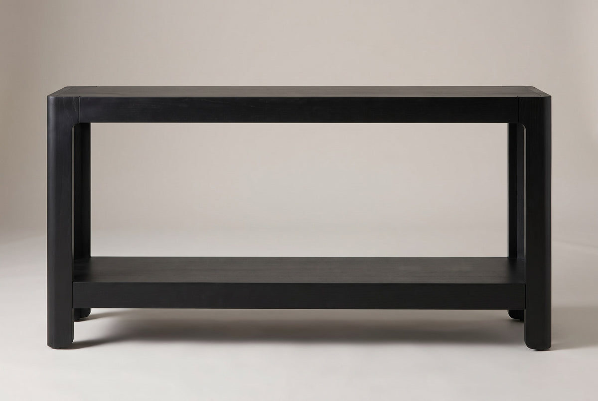 Sarnico console table in black, straight front view: four rounded legs, a deep top apron and a thick lower shelf