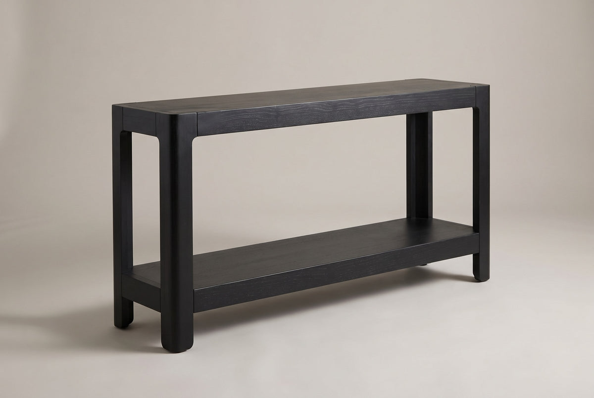 Sarnico farmhouse console table in black, three-quarter view on a warm grey studio backdrop