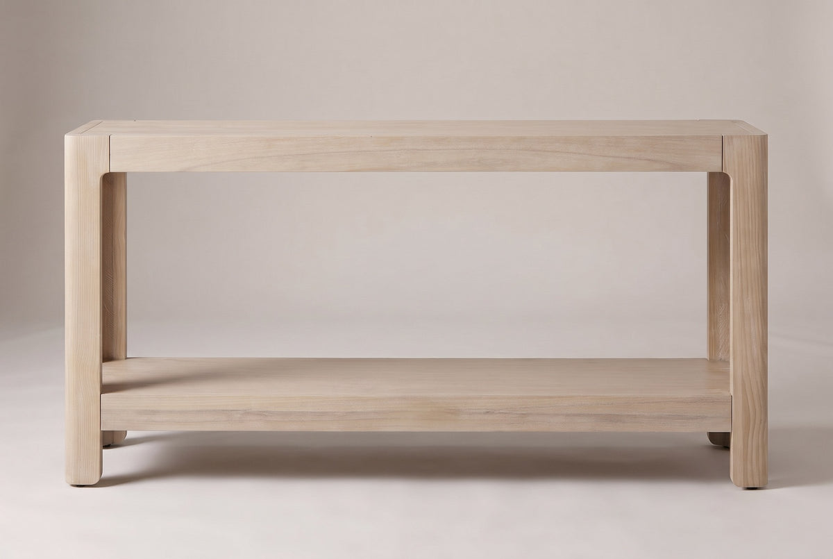 Sarnico console table in natural, straight front view: four rounded legs, a deep top apron and a thick lower shelf