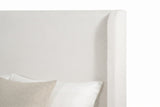 Close-up of the ivory chenille headboard and one slim wing with its rounded top corner