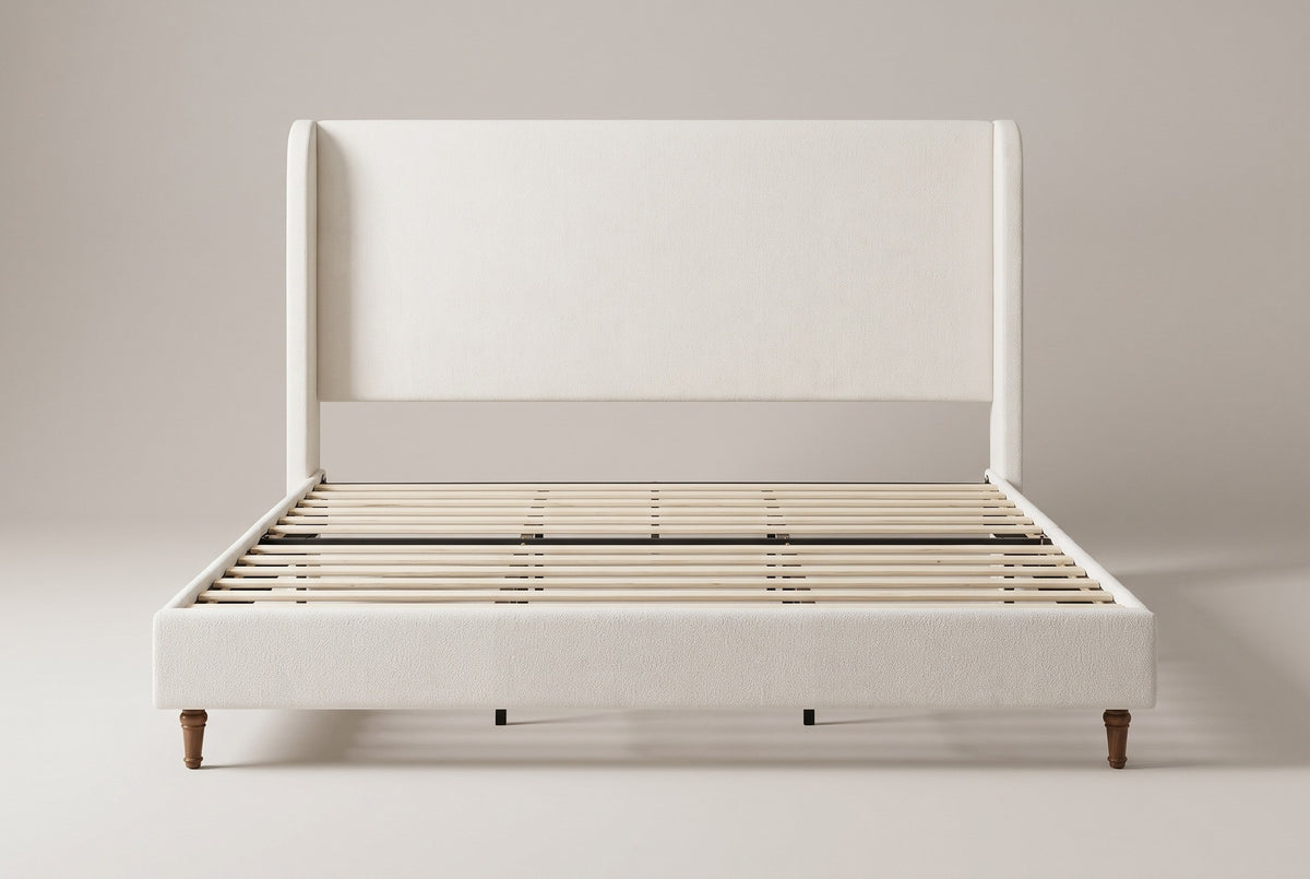 Sarzana wingback bed in ivory chenille, straight front view on a studio backdrop