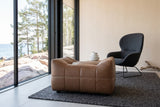 Sassocorvaro ottoman in Antique Sienna seen low from its dipped side in a Helsinki seaside villa