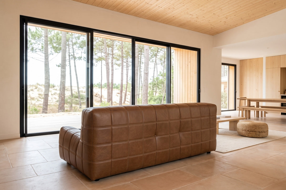 Sassocorvaro sofa in Antique Sienna seen from behind in a Hossegor pine house, its padded back to the camera