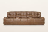 Sassocorvaro sofa in Antique Sienna, straight front view on a warm white studio backdrop: the seat rises in two soft humps