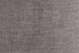 Close-up of the dark taupe velvet: a soft mottled pile in warm grey with a faint mauve cast