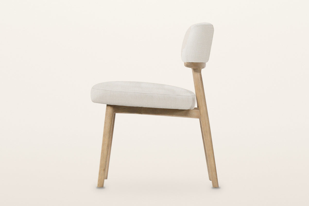 Savoca dining chair in Porcelain Chenille, side view on a warm white studio backdrop