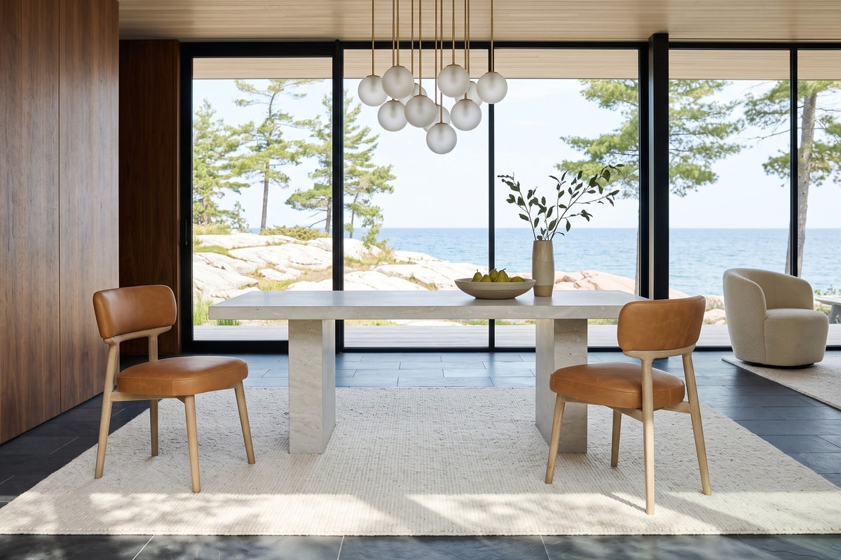 Two Savoca dining chairs in Tawny leather at a limestone block table in a Killarney house on the North Channel