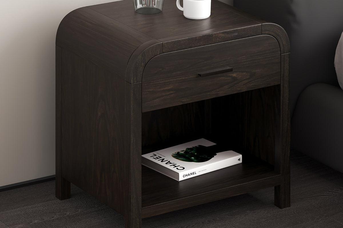 Saylor dark walnut accent table beside a grey sofa with a vase and books