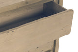 Close-up of the Scheggino top drawer pulled out: the rounded pine front with nail holes and the drawer box behind it