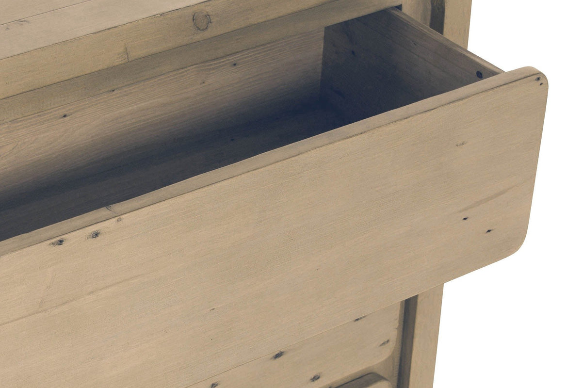 Close-up of the Scheggino top drawer pulled out: the rounded pine front with nail holes and the drawer box behind it