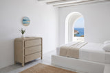 Scheggino chest in a bedroom of a Patmos cliff house, with white lime plaster, a cedar-pole ceiling