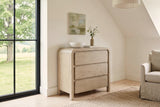 Scheggino chest in a Stanstead stone house in the Eastern Townships, with warm white limewash, a sloped ceiling