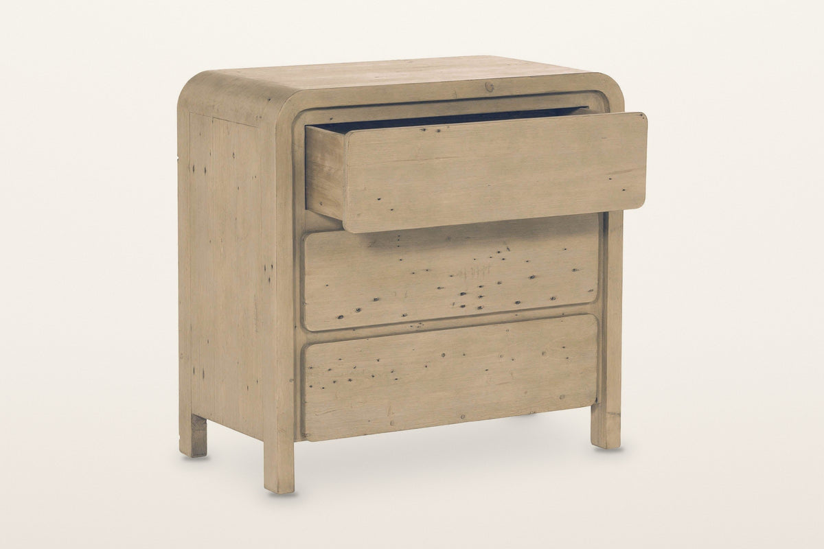 Scheggino chest in Brown with the top drawer pulled out on a warm white studio backdrop