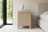 Side view of the Scheggino nightstand in pale reclaimed pine in an Aarhus bedroom