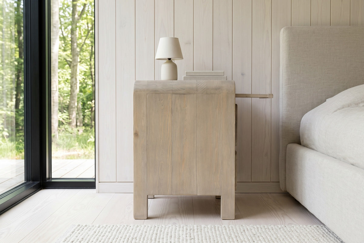 Side view of the Scheggino nightstand in pale reclaimed pine in an Aarhus bedroom