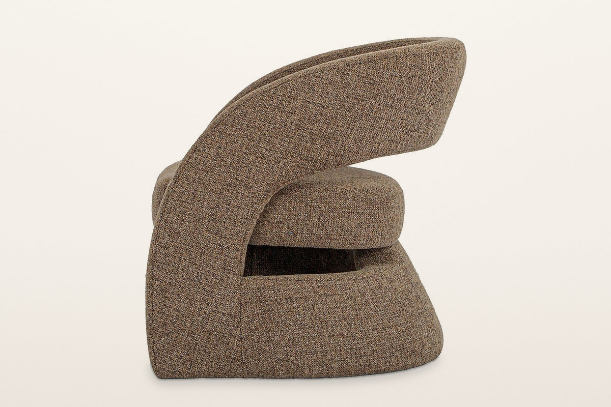 Sefro accent chair in Chocolate from the side on a warm white studio backdrop
