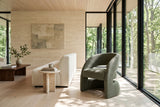 Sefro accent chair in Green in a house on the Hamilton escarpment, with a travertine wall