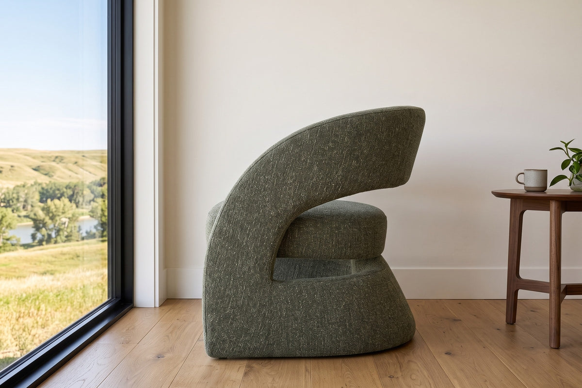 Sefro accent chair in Green in side profile in a Lethbridge coulee house, with limewashed walls and a window to the coulees
