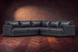 Serena corner sectional in Aged Slate on a walnut herringbone floor, three-quarter view.
