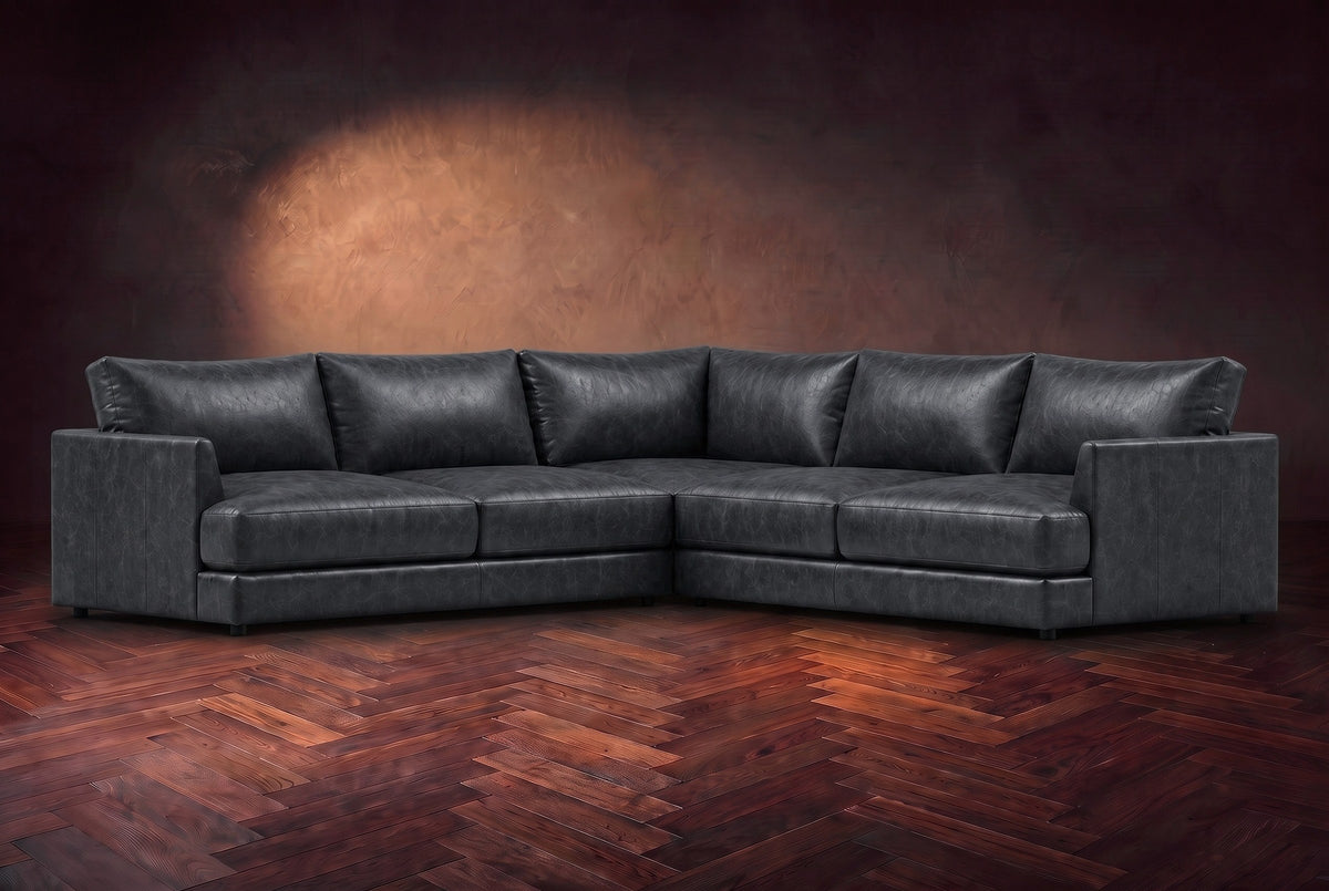 Serena corner sectional in Aged Slate on a walnut herringbone floor, three-quarter view.