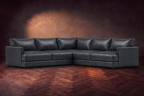 Serena corner sectional in Aged Slate on a walnut herringbone floor, three-quarter view.