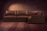 Serena corner sectional in Burnished Chestnut on a walnut herringbone floor, seen from the front with the near side on the right.