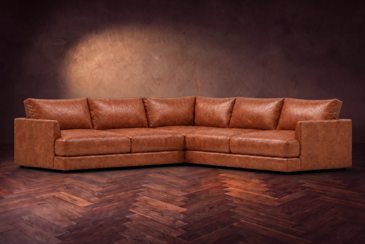 Serena corner sectional in Tuscan Cognac on a walnut herringbone floor, three-quarter view.