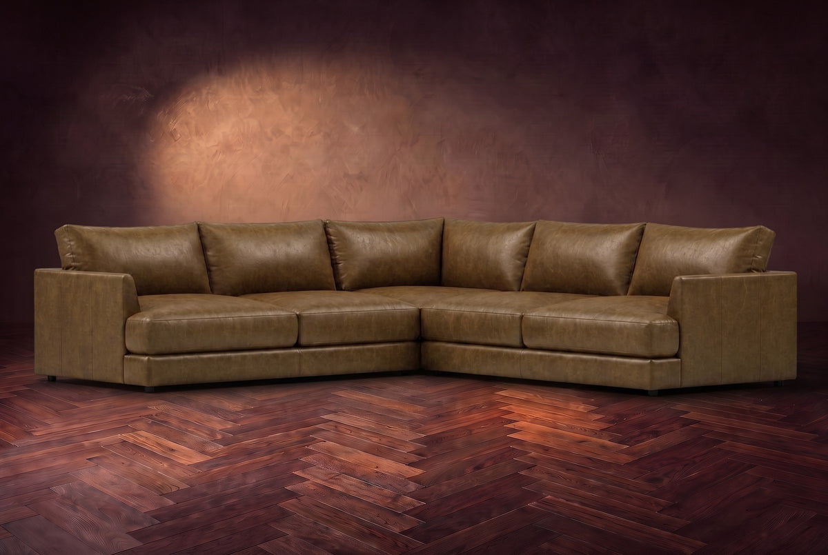 Serena corner sectional in Weathered Saddle on a walnut herringbone floor, three-quarter view.