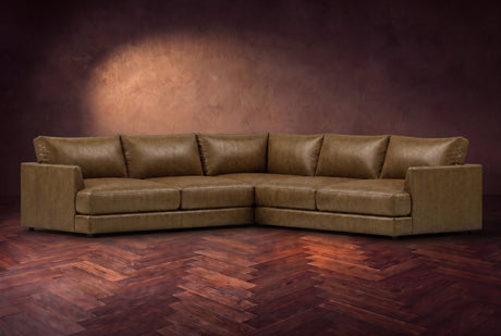 Serena corner sectional in Weathered Saddle on a walnut herringbone floor, three-quarter view.