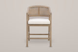 Sermoneta counter stool in Natural Ash, straight front view showing the tub back, the cane-look panel