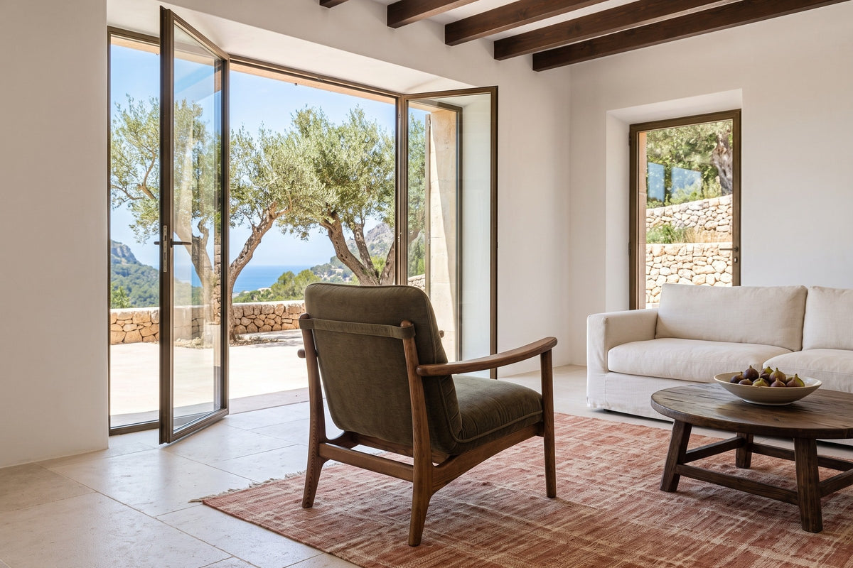 Servigliano accent chair in Green seen from behind in a Deia stone house on Mallorca, white lime plaster