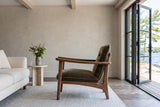 Servigliano accent chair in Green in side profile in a Rosseau lake house in Muskoka