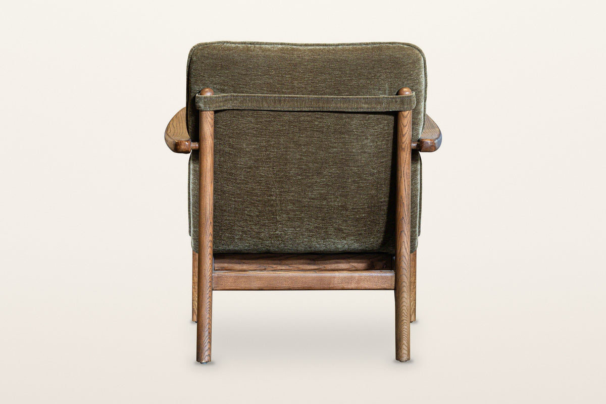 Back of the Servigliano accent chair in Green on a warm white studio backdrop: a fabric strap between the two back posts hold