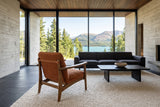 Servigliano accent chair in Rust seen from behind in a Tagish lake house in the Yukon