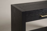 Close-up of the top corner where the black slab side frames the top and the drawer