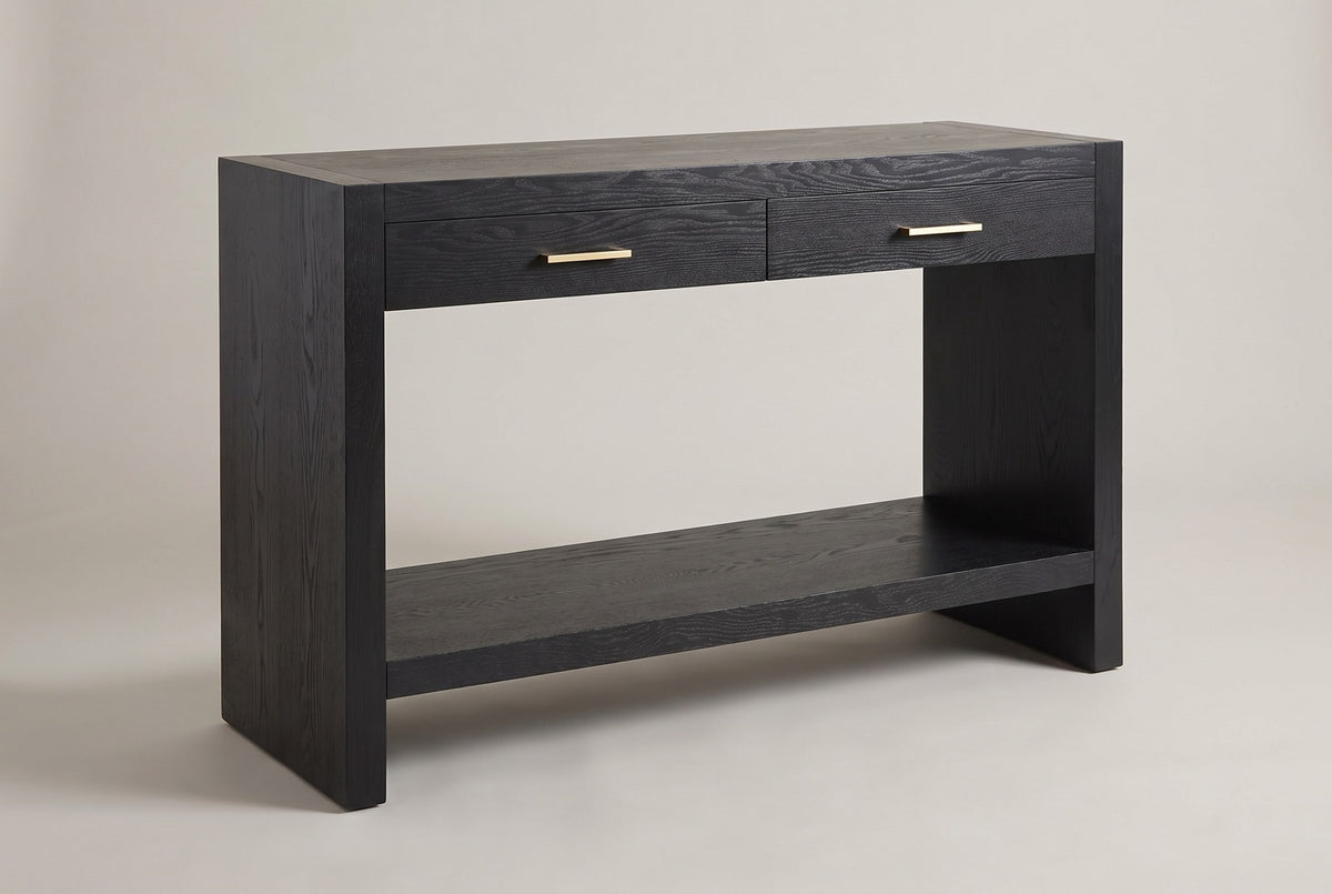 Sibari 2-drawer console table in black, three-quarter view on a warm grey studio backdrop