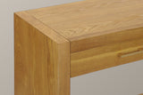 Close-up of the top corner where the Natural slab side frames the top and the drawer