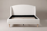 Sirmione wingback bed, straight front view: arched boucle headboard between two rounded wings