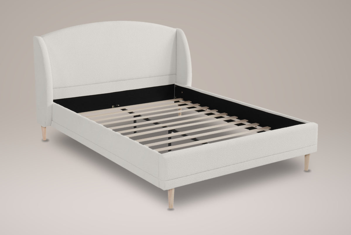 Sirmione boucle wingback bed in white, three-quarter view on a warm grey studio backdrop