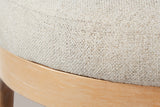 Close-up of the beige linen-blend seat with its seam round the top edge and the brushed wood ring under it