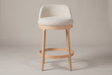 Sirolo counter stool, straight front view showing the round seat, the low wrap-around back, four legs and the footrest ring