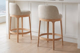 Two Sirolo counter stools pulled out from a white shaker island with a quartz top on a pale oak floor in a Vancouver kitchen