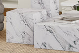Sloane white marble-look concrete cube grouped with other block tables on a jute rug